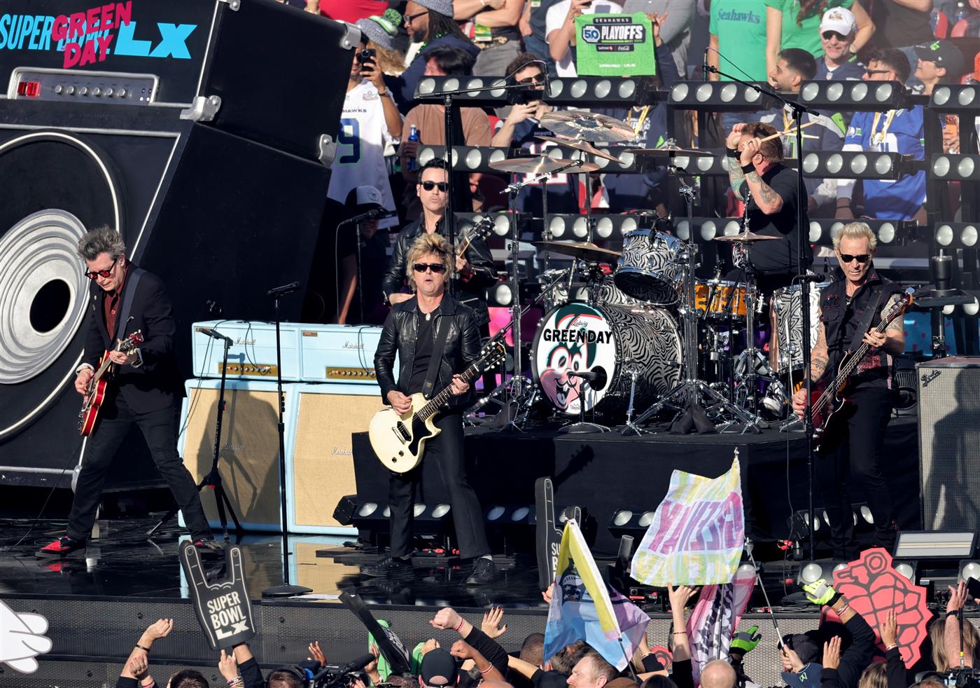 SANTA CLARA, CALIFORNIA - FEBRUARY 08: (L-R) Billie Joe Armstrong, Tré Cool and Mike Dirnt of Green Day perform during Super Bowl LX at Levi