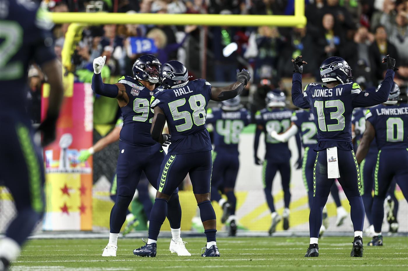SANTA CLARA, CALIFORNIA - FEBRUARY 8: Derick Hall #58 of the Seattle Seahawks celebrates after forcing a fumble during the third quarter of the NFL Super Bowl LX football game against the New England Patriots, at Levi