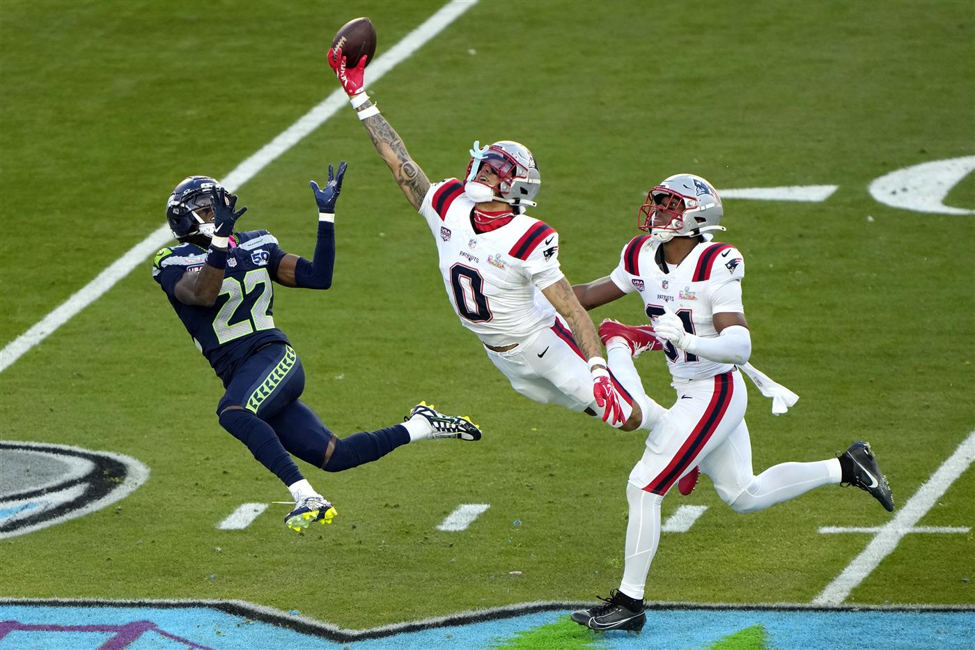 SANTA CLARA, CALIFORNIA - FEBRUARY 08: Christian Gonzalez #0 of the New England Patriots breaks up a pass intended for for Rashid Shaheed #22 of the Seattle Seahawks during the second quarter in Super Bowl LX at Levi