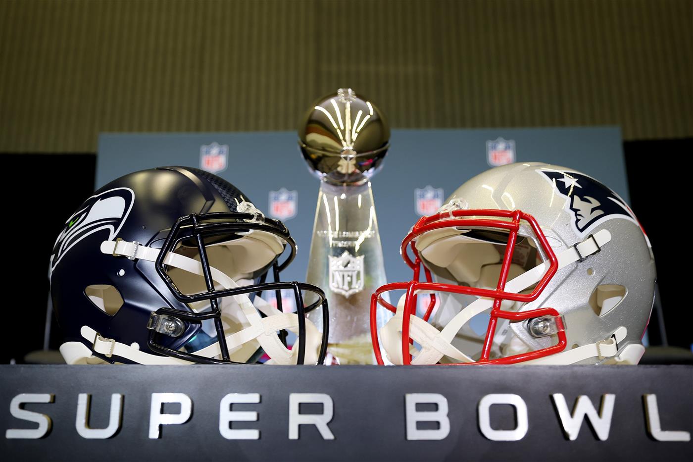 SAN JOSE, CALIFORNIA - FEBRUARY 02: The Vince Lombardi Trophy is framed by the Seattle Seahawks and New England Patriots helmets during Super Bowl LX Opening Night at San Jose McEnery Convention Center on February 02, 2026 in San Jose, California. (Photo by Chris Graythen/Getty Images)