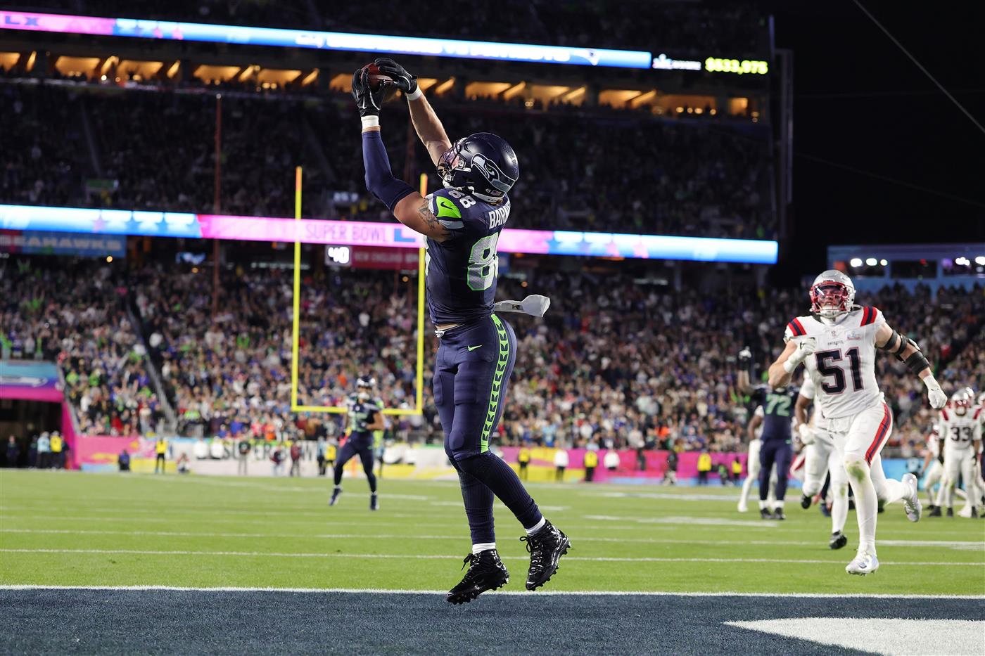 SANTA CLARA, CALIFORNIA - FEBRUARY 08: AJ Barner #88 of the Seattle Seahawks scores a touchdown against the New England Patriots during the fourth quarter of Super Bowl LX at Levi