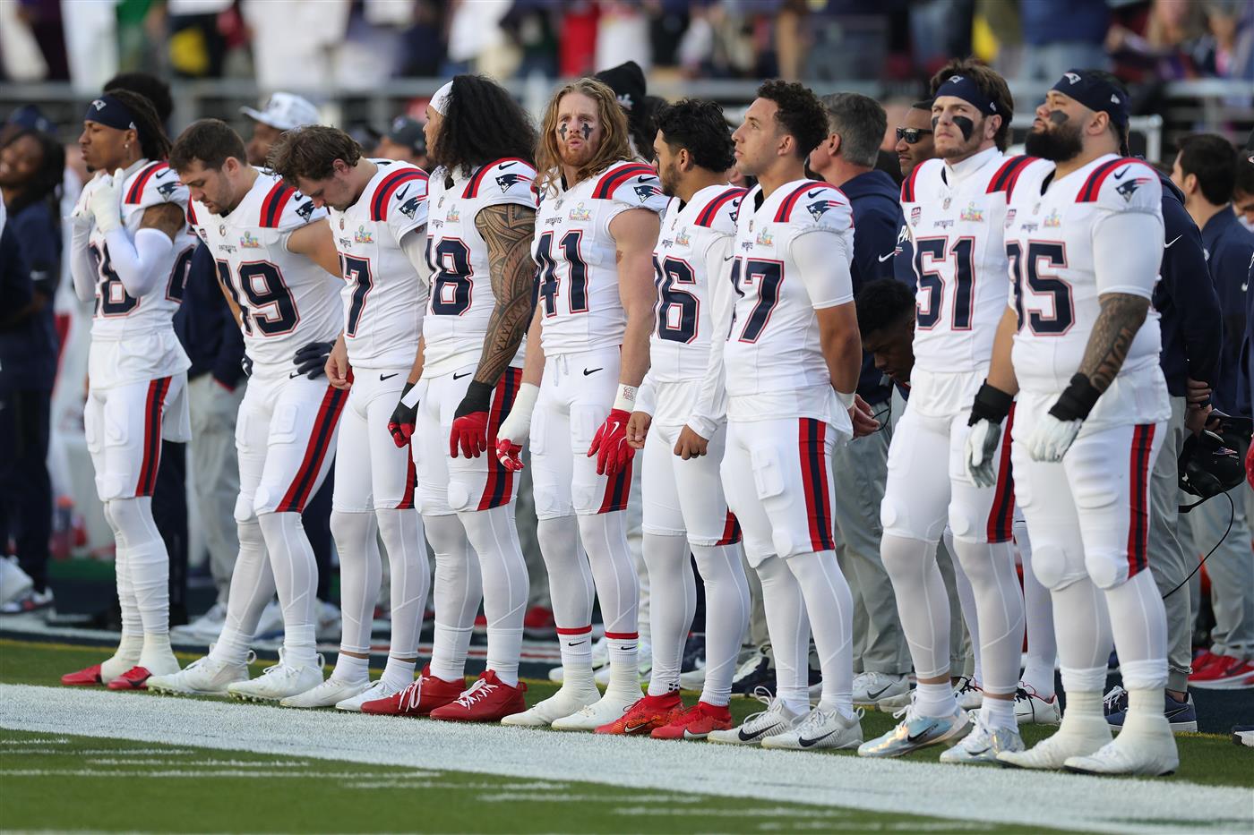 SANTA CLARA, CALIFORNIA - FEBRUARY 08: New England Patriots stand on the sideline during the first quarter of Super Bowl LX against the Seattle Seahawks at Levi