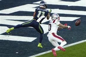 SANTA CLARA, CALIFORNIA - FEBRUARY 08: Christian Gonzalez #0 of the New England Patriots breaks up a pass intended for Jaxon Smith-Njigba #11 of the Seattle Seahawks during the second quarter in Super Bowl LX at Levi