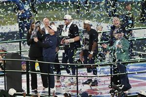 SANTA CLARA, CALIFORNIA - FEBRUARY 08: Head coach Mike MacDonald of the Seattle Seahawks hoists the Vince Lombardi Trophy after defeating the New England Patriots 29-13 to win  Super Bowl LX at Levi