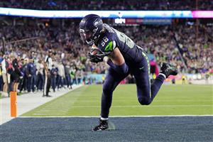 SANTA CLARA, CALIFORNIA - FEBRUARY 08: AJ Barner #88 of the Seattle Seahawks scores a touchdown against the New England Patriots during the fourth quarter of Super Bowl LX at Levi