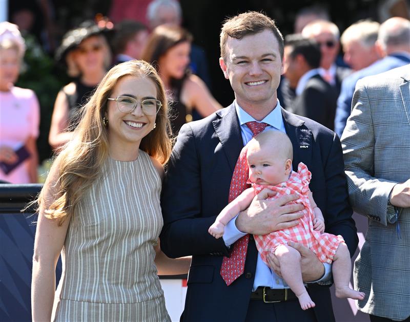 MELBOURNE, AUSTRALIA - FEBRUARY 14: Grace Ramage and Ben Hayes pose with daughter Indiana after Cafe Millenium won Race 7, the The Elms Handicap during Melbourne Racing at Flemington Racecourse on February 14, 2026 in Melbourne, Australia. (Photo by Vince Caligiuri/Getty Images)
