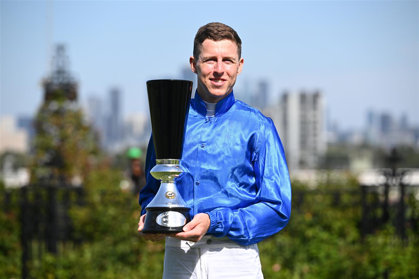 MELBOURNE, AUSTRALIA - FEBRUARY 14: Damian Lane poses with trophy after riding Tentyris to win Race 8, the Black Caviar Lightning  during Melbourne Racing at Flemington Racecourse on February 14, 2026 in Melbourne, Australia. (Photo by Vince Caligiuri/Getty Images)
