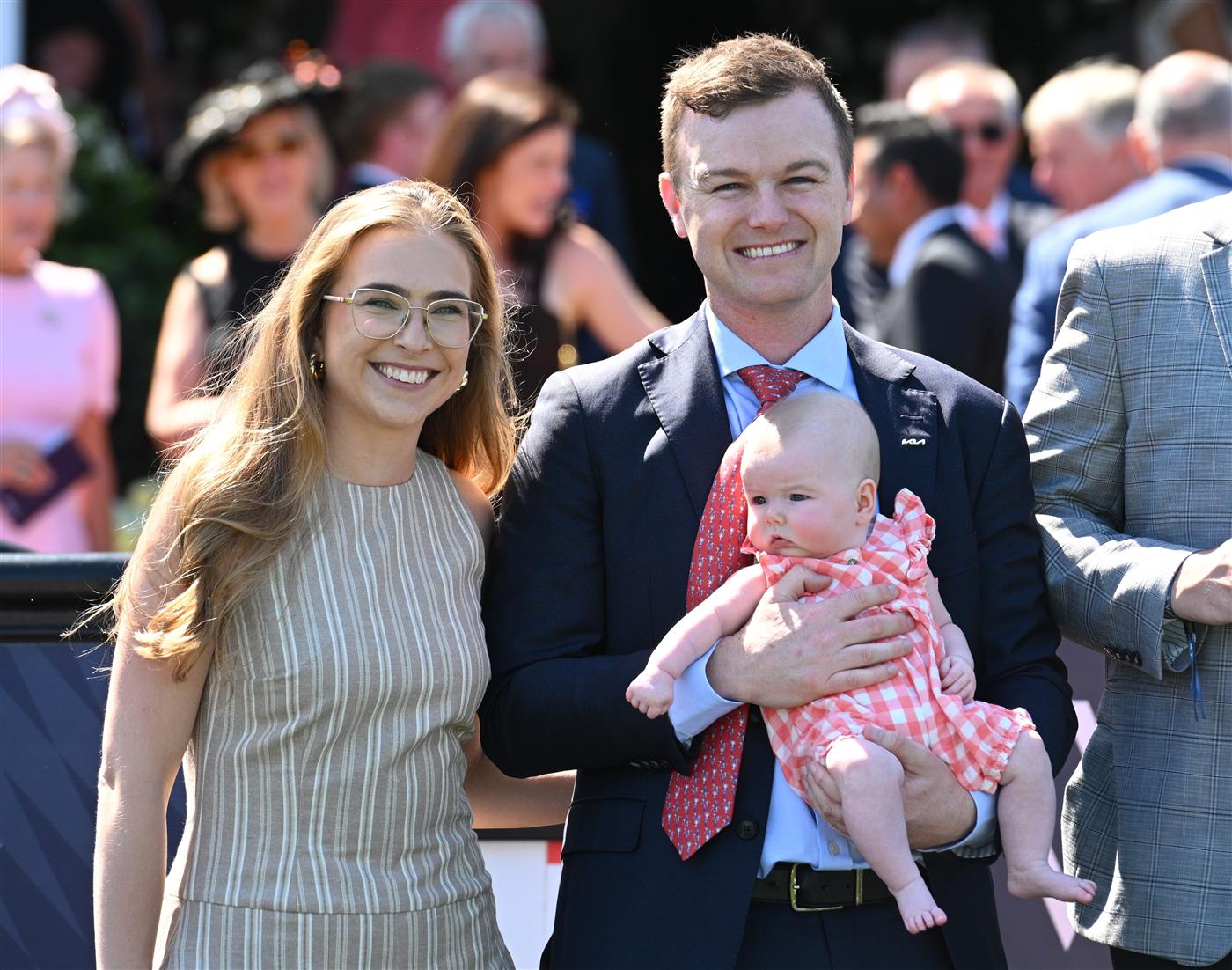 MELBOURNE, AUSTRALIA - FEBRUARY 14: Grace Ramage and Ben Hayes pose with daughter Indiana after Cafe Millenium won Race 7, the The Elms Handicap during Melbourne Racing at Flemington Racecourse on February 14, 2026 in Melbourne, Australia. (Photo by Vince Caligiuri/Getty Images)