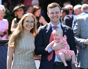 MELBOURNE, AUSTRALIA - FEBRUARY 14: Grace Ramage and Ben Hayes pose with daughter Indiana after Cafe Millenium won Race 7, the The Elms Handicap during Melbourne Racing at Flemington Racecourse on February 14, 2026 in Melbourne, Australia. (Photo by Vince Caligiuri/Getty Images)