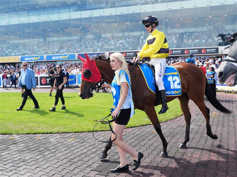 MELBOURNE, AUSTRALIA - FEBRUARY 21: Winning strapper Olivia Featherston and Streisand before winning Race 8, the Sportsbet Blue Diamond Stakes during Melbourne Racing at Caulfield Racecourse on February 21, 2026 in Melbourne, Australia. (Photo by Vince Caligiuri/Getty Images)