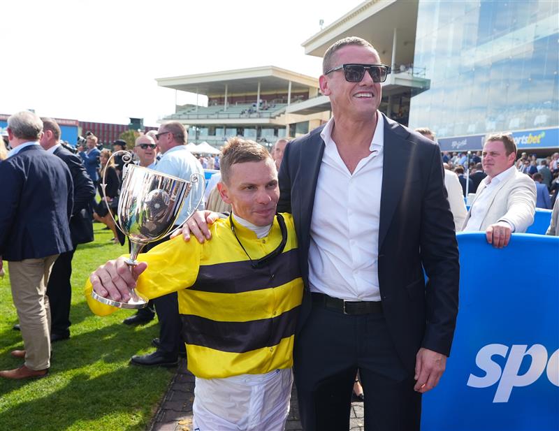 MELBOURNE, AUSTRALIA - FEBRUARY 21: Ben Melham poses with part owner Michael Gardiner after riding Streisand to win in Race 8, the Sportsbet Blue Diamond Stakes during Melbourne Racing at Caulfield Racecourse on February 21, 2026 in Melbourne, Australia. (Photo by Vince Caligiuri/Getty Images)