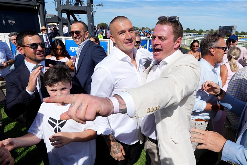 MELBOURNE, AUSTRALIA - FEBRUARY 21: Winning connections  including ex Richmond champion, Dustin Martin (L) celebrates after Streisand won Race 8, the Sportsbet Blue Diamond Stakes during Melbourne Racing at Caulfield Racecourse on February 21, 2026 in Melbourne, Australia. (Photo by Vince Caligiuri/Getty Images)