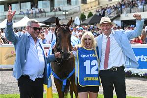 MELBOURNE, AUSTRALIA - FEBRUARY 21: Winning strapper celebrates with Trainer Clinton McDonald and Shane McGrath (r) after Streisand won Race 8, the Sportsbet Blue Diamond Stakes during Melbourne Racing at Caulfield Racecourse on February 21, 2026 in Melbourne, Australia. (Photo by Vince Caligiuri/Getty Images)