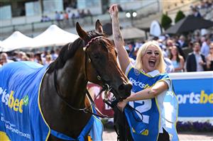 MELBOURNE, AUSTRALIA - FEBRUARY 21: Winning strapper celebrates after Streisand won Race 8, the Sportsbet Blue Diamond Stakes during Melbourne Racing at Caulfield Racecourse on February 21, 2026 in Melbourne, Australia. (Photo by Vince Caligiuri/Getty Images)