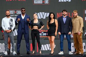 Nakisa Bidarian, Francis Ngannou, Ronda Rousey, Gina Carano, Philipe Lins, and Jake Paul pose onstage during Netflix's Ronda Rousey x Gina Carano Los Angeles MMA Press Conference at Intuit Dome on March 10, 2026 in Inglewood, California. (Getty Images for Netflix)