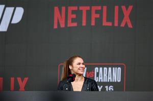 Ronda Rousey speaks onstage during Netflix's Ronda Rousey x Gina Carano Los Angeles MMA Press Conference at Intuit Dome on March 10, 2026 in Inglewood, California. (Getty Images for Netflix)