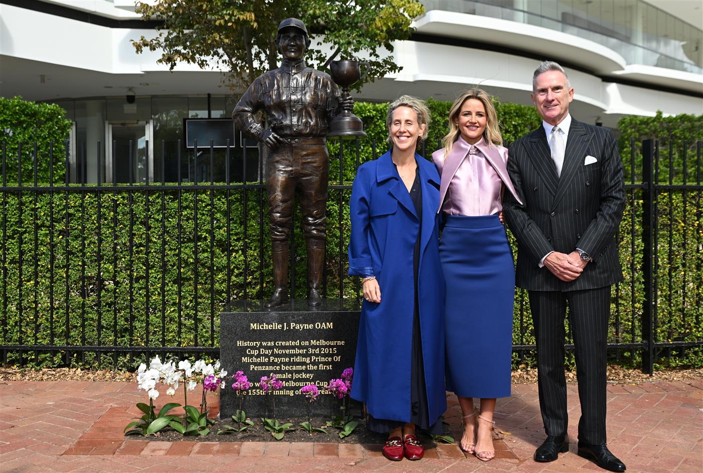 MELBOURNE, AUSTRALIA - MARCH 26: Michelle Payne, the first female jockey to win Australia’s most iconic race, the Lexus Melbourne Cup aboard Prince of Penzance poses with Kylie Rogers – VRC CEO and Neil Wilson – VRC Chairman during the official unveiling of the Michelle Payne Statue at Flemington Racecourse on March 26, 2026 in Melbourne, Australia. (Photo by Vince Caligiuri/Getty Images)