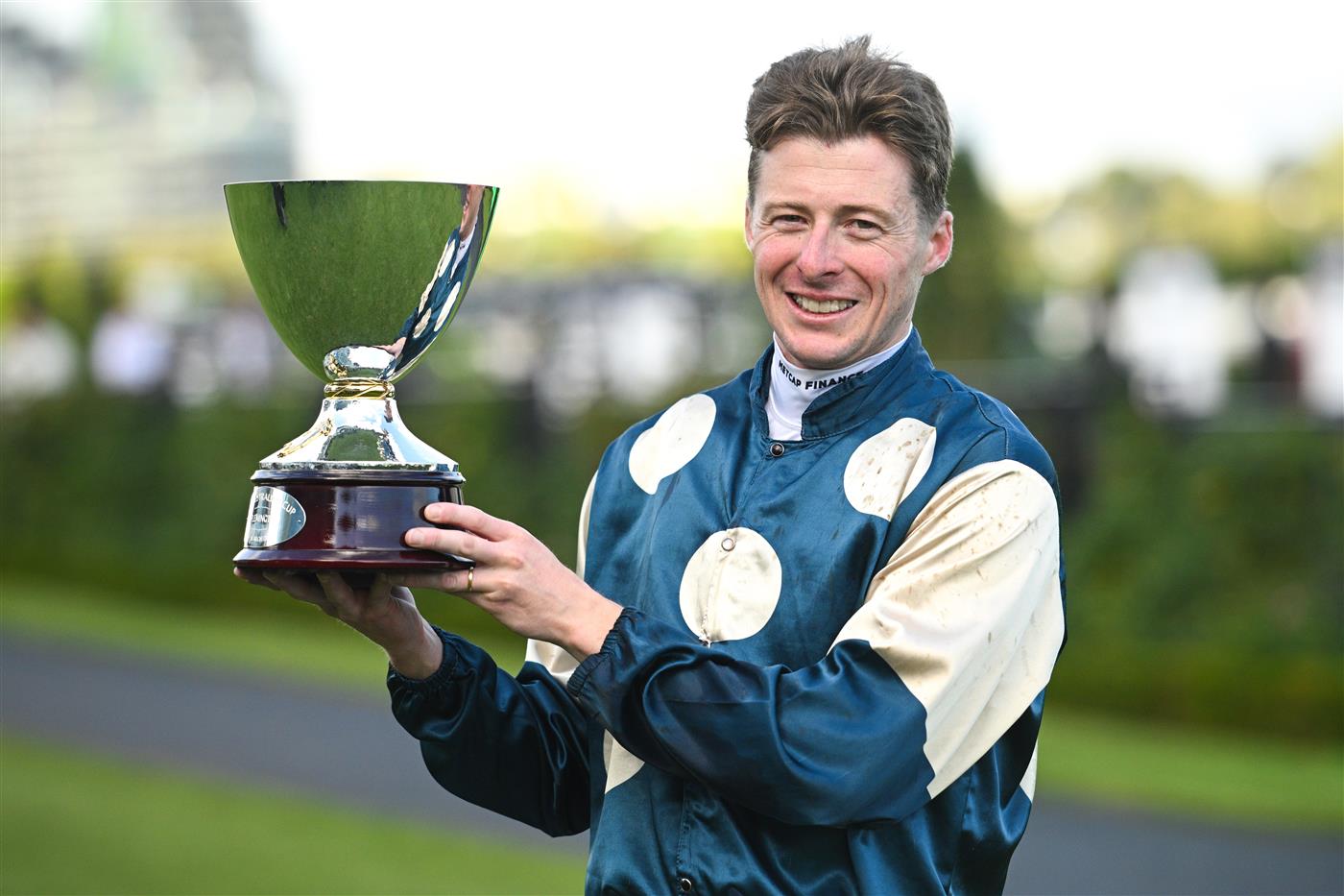 MELBOURNE, AUSTRALIA - MARCH 28: Harry Coffey poses with the trophy after riding Light Infantry Man to win Race 8, the Tab Australian Cup during Melbourne Racing at Flemington Racecourse on March 28, 2026 in Melbourne, Australia. (Photo by Vince Caligiuri/Getty Images)