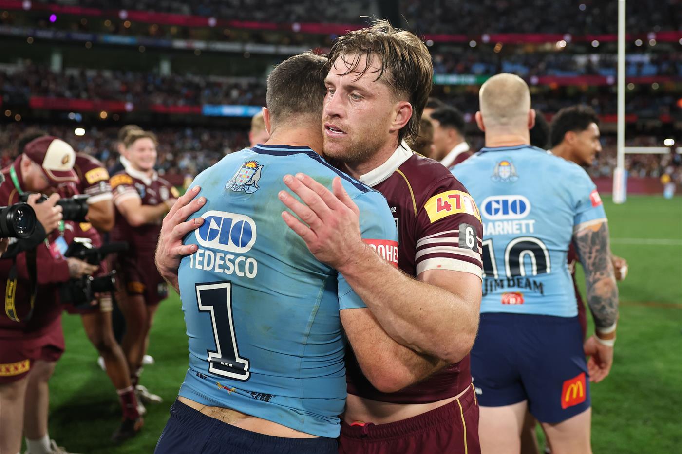 James Tedesco of the New South Wales Blues and Cameron Munster of the Queensland Maroons embrace at full-time following Game 2 of the 2026 State of Origin series at the Melbourne Cricket Ground on June 17, 2026 in Melbourne, Australia. (Getty)