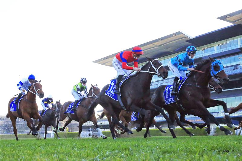 SYDNEY, AUSTRALIA - AUGUST 21: Tommy Berry (blue and black checks) on Mo'unga winning the 2021 Winx Stakes at Royal Randwick. (Getty)