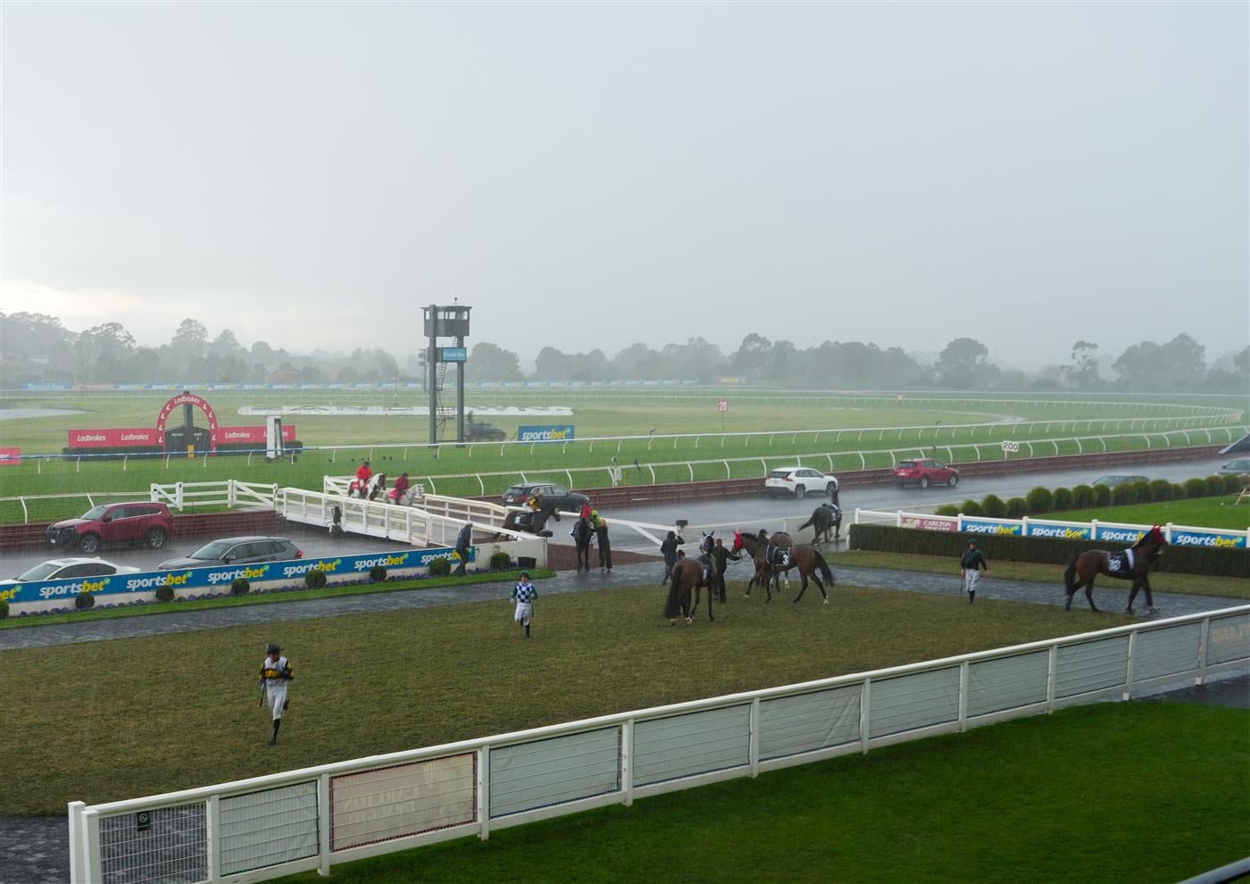 MELBOURNE, AUSTRALIA - SEPTEMBER 05: Jockeys make a quick return to the mounting yard as races are delayed due to storms and lightning before race 9, the Orbit Logistics Chautauqua Stakes during Melbourne Racing at Sandown Racecourse on September 05, 2026 in Melbourne, Australia. (Photo by Vince Caligiuri/Getty Images)