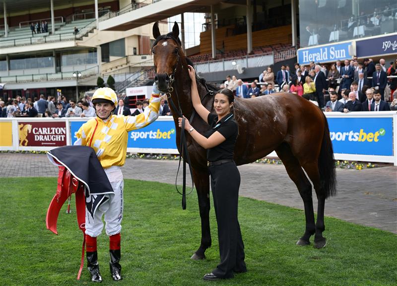 MELBOURNE, AUSTRALIA - SEPTEMBER 20: Craig Williams poses with strapper Mia Smith after riding Sir Delius to win in Race 7, the Sen Underwood Stakes during Melbourne Racing at Caulfield Racecourse on September 20, 2025 in Melbourne, Australia. (Photo by Vince Caligiuri/Getty Images)