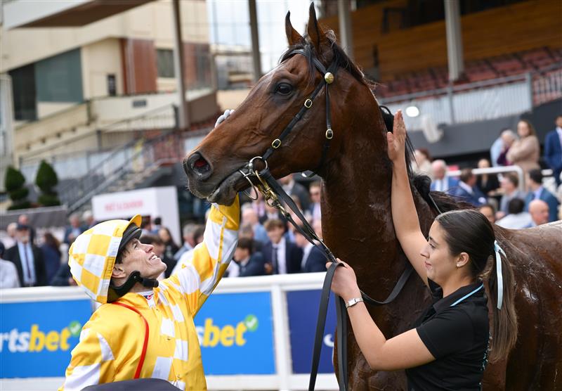 MELBOURNE, AUSTRALIA - SEPTEMBER 20: Craig Williams poses with strapper Mia Smith after riding Sir Delius to win in Race 7, the Sen Underwood Stakes during Melbourne Racing at Caulfield Racecourse on September 20, 2025 in Melbourne, Australia. (Photo by Vince Caligiuri/Getty Images)