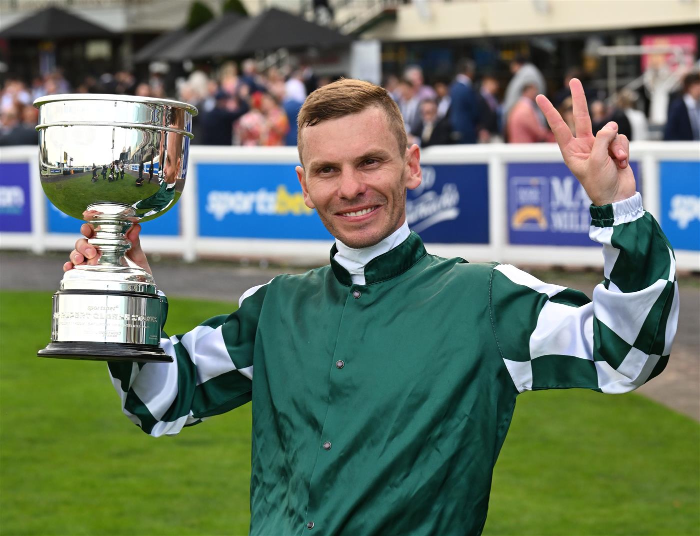 MELBOURNE, AUSTRALIA - SEPTEMBER 19: Ben Melham poses with the trophy after riding Angel Capital to win race 9, the Sportsbet Sir Rupert Clarke Stakes during Melbourne Racing at Caulfield Racecourse on September 19, 2026 in Melbourne, Australia. (Photo by Vince Caligiuri/Getty Images)