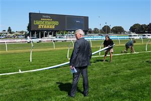 MELBOURNE, AUSTRALIA - SEPTEMBER 19: Chief steward Rob Montgomery inspecting the track after divots where seen close to the original rail position before Melbourne Racing at Caulfield Racecourse on September 19, 2026 in Melbourne, Australia. (Photo by Vince Caligiuri/Getty Images)
