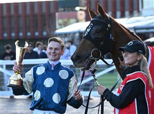 MELBOURNE, AUSTRALIA - SEPTEMBER 27: Ethan Brown  poses with trophy after riding Jimmysstar to win race 8, the Ladbrokes Manikato Stakes  during Melbourne Racing at Caulfield Racecourse on September 27, 2026 in Melbourne, Australia. (Photo by Vince Caligiuri/Getty Images)