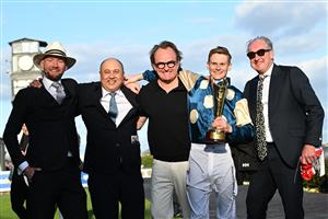 MELBOURNE, AUSTRALIA - SEPTEMBER 27: Ethan Brown poses with trainer Ciaron Maher and connections after riding Jimmysstar to win race 8, the Ladbrokes Manikato Stakes  during Melbourne Racing at Caulfield Racecourse on September 27, 2026 in Melbourne, Australia. (Photo by Vince Caligiuri/Getty Images)