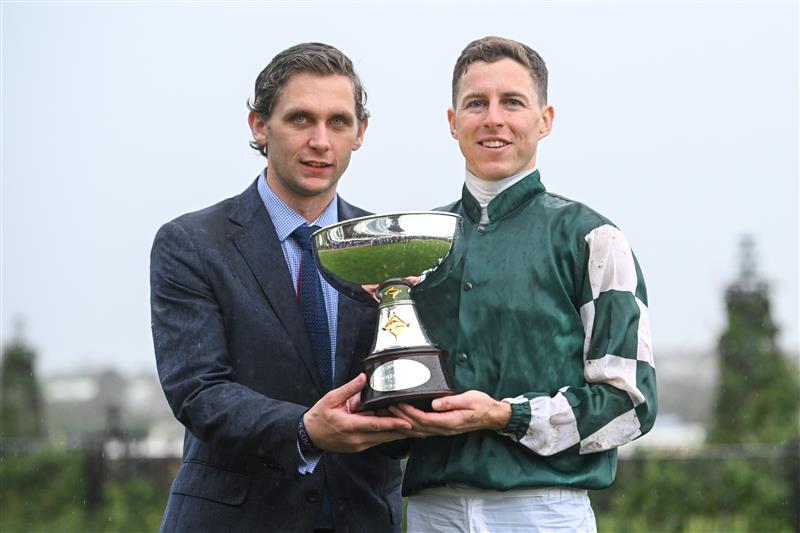 MELBOURNE, AUSTRALIA - OCTOBER 05: Damian Lane and Charlie Duckworth, assistant trainer to Chris Waller pose with the trophy after Via Sistina won Race 8, theTab Turnbull Stakes - Betting Odds during Melbourne Racing at Flemington Racecourse on October 05, 2024 in Melbourne, Australia. (Photo by Vince Caligiuri/Getty Images)