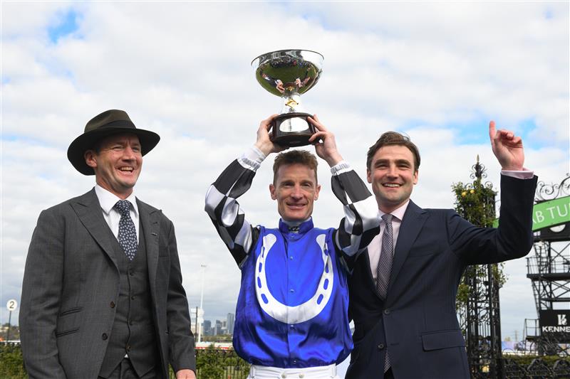 MELBOURNE, AUSTRALIA - OCTOBER 07: Mark Zahra after riding Gold Trip poses with trainer Ciaron Maher and David Eustace with the trophy after winning Race 8, the Tab Turnbull Stakes, during Melbourne Racing at Flemington Racecourse on October 07, 2023 in Melbourne, Australia. (Photo by Vince Caligiuri/Getty Images)