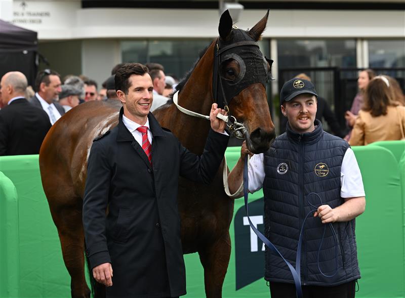 MELBOURNE, AUSTRALIA - OCTOBER 03: Trainer Michael Kent Jnr poses with Miss Waititi after winning race 3, the Howden Super Impose Stakes during Turnbull Stakes Day at Flemington Racecourse on October 03, 2026 in Melbourne, Australia. (Photo by Vince Caligiuri/Getty Images)