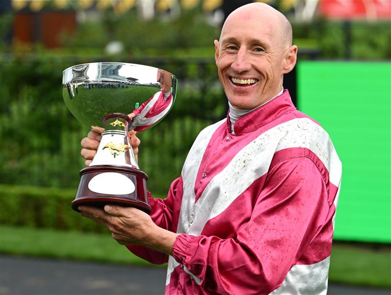 MELBOURNE, AUSTRALIA - OCTOBER 03: William Pike poses with trophy after riding Cosmic Crusader to win race 8, the Tab Turnbull Stakes  during Turnbull Stakes Day at Flemington Racecourse on October 03, 2026 in Melbourne, Australia. (Photo by Vince Caligiuri/Getty Images)