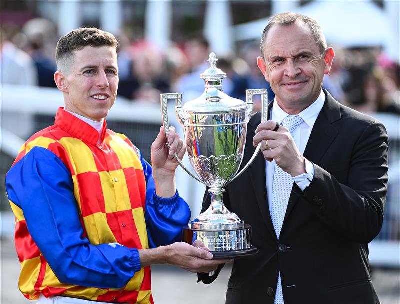 MELBOURNE, AUSTRALIA - OCTOBER 11: Damian Lane poses with Trainer Chris Waller after riding Autumn Boy to win Race 8, the Sportsbet Caulfield Guineas during Melbourne Racing at Caulfield Racecourse on October 11, 2025 in Melbourne, Australia. (Photo by Vince Caligiuri/Getty Images)