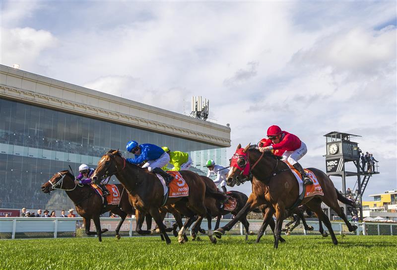 MELBOURNE, AUSTRALIA - OCTOBER 08: James McDonald riding Golden Mile (ctr) defaets Elliptical and Osipenko (L) in Race 8, the Neds Caulfield Guineas,  during Caulfield Guineas Day at Caulfield Racecourse on October 08, 2022 in Melbourne, Australia. (Photo by Vince Caligiuri/Getty Images)