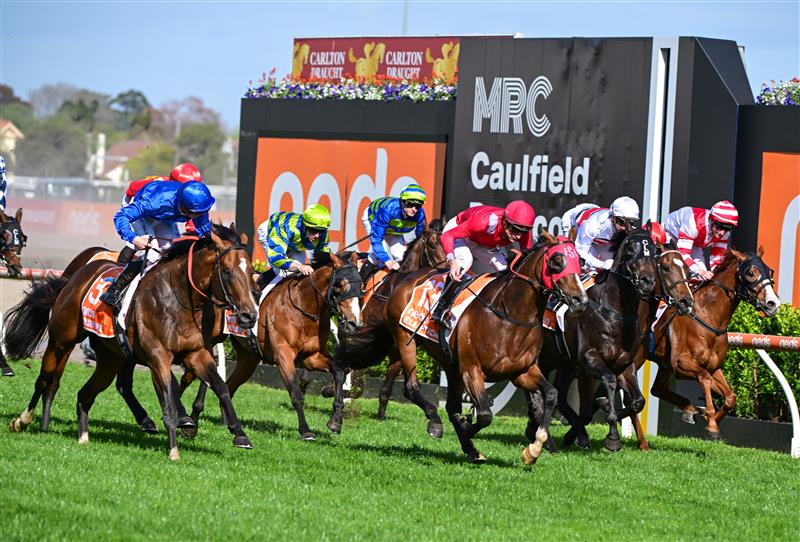 MELBOURNE, AUSTRALIA - OCTOBER 08: James McDonald riding Golden Mile (L) winning Race 8, the Neds Caulfield Guineas,  during Caulfield Guineas Day at Caulfield Racecourse on October 08, 2022 in Melbourne, Australia. (Photo by Vince Caligiuri/Getty Images)