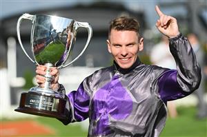 MELBOURNE, AUSTRALIA - OCTOBER 14: Ben Melham poses with the trophy after  riding Griff to win Race 9, the Neds Caulfield Guineas, during Melbourne Racing at Caulfield Racecourse on October 14, 2023 in Melbourne, Australia. (Photo by Vince Caligiuri/Getty Images)