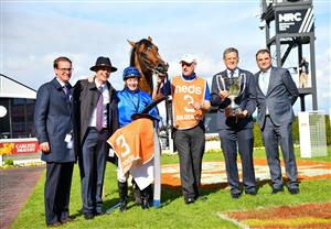 MELBOURNE, AUSTRALIA - OCTOBER 08: James McDonald poses with Trainer James Cummings and connections after riding Golden Mile to win Race 8, the Neds Caulfield Guineas,  during Caulfield Guineas Day at Caulfield Racecourse on October 08, 2022 in Melbourne, Australia. (Photo by Vince Caligiuri/Getty Images)