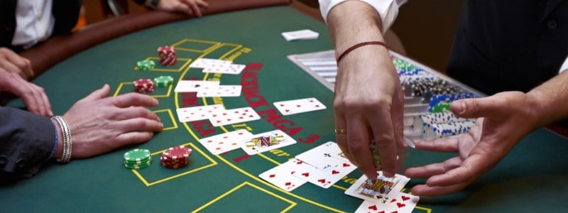 Blackjack casino dealer taking chips Blackjack casino dealer taking chips