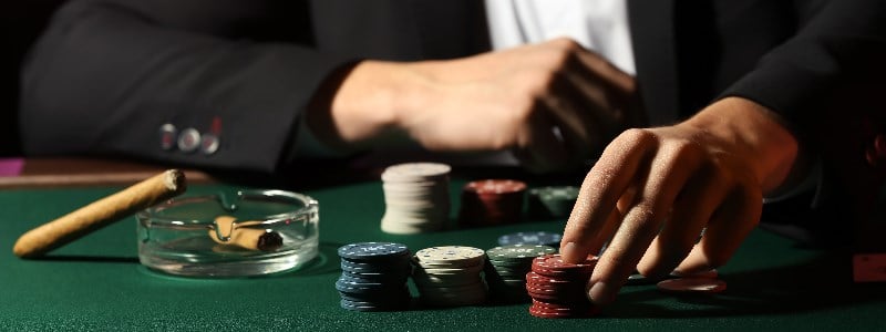 High roller casino player toying with chips