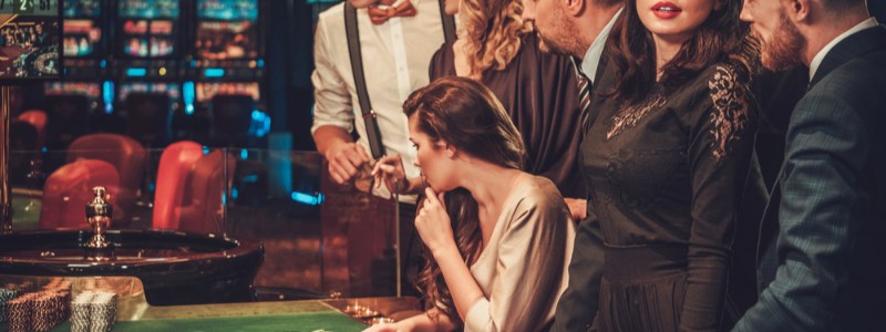 Roulette game with players watching wheel Roulette game with players watching wheel