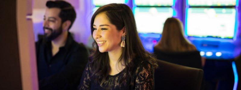 Woman playing new slots at casino