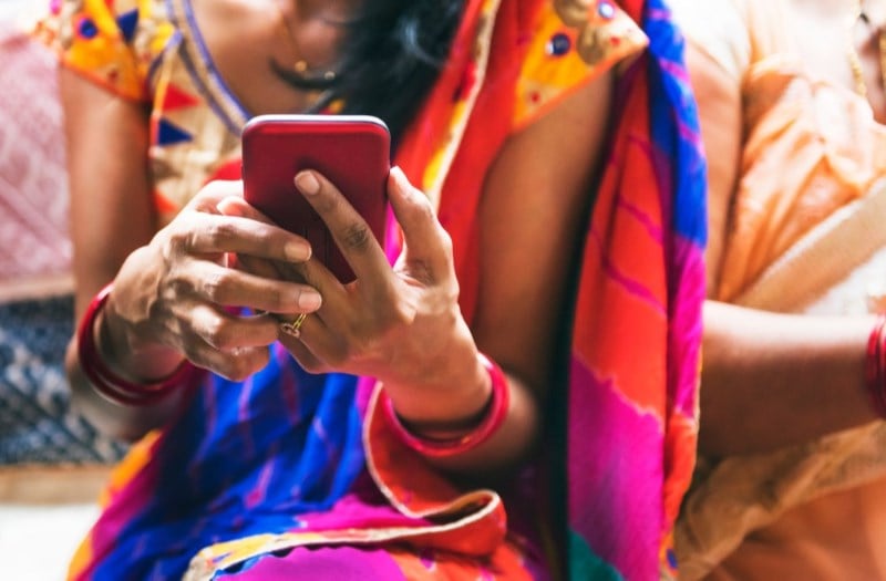 Indian gambler on mobile phone