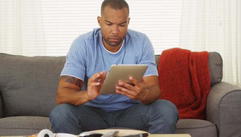 Man gambling on tablet from kenya Man gambling on tablet from kenya