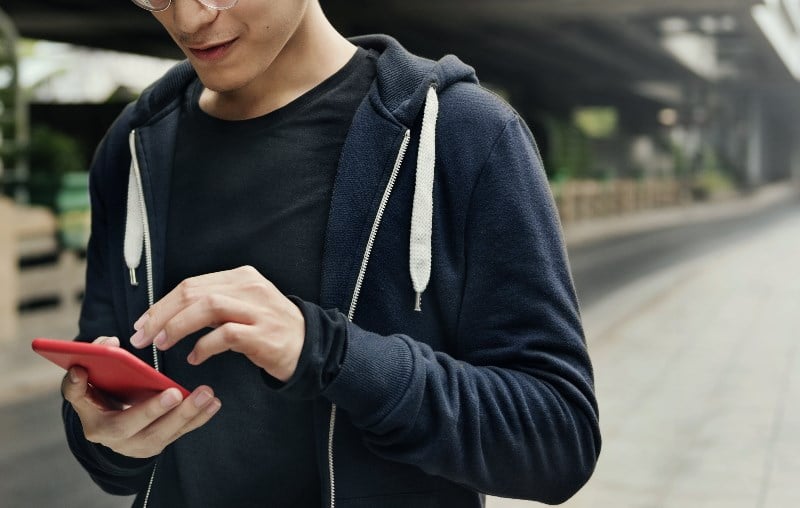 Swiss man playing games on phone