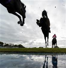 WINCANTON, ENGLAND - OCTOBER 15: Ben Poste riding Dollar And A Dream (C) clear the water jump on their way to winning The Use The racingtv.com Tracker Novices' Handicap Chase at Wincanton Racecourse on October 15, 2020 in Wincanton, England. Owners are allowed to attend if they have a runner at the meeting otherwise racing remains behind closed doors to the public due to the Coronavirus pandemic. (Photo by Alan Crowhurst/Getty Images)