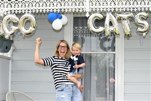 GEELONG, AUSTRALIA - OCTOBER 21: Elise Davey and her son George Mcauley-Powell pose in front of their home on October 21, 2020 in Geelong, Australia. The Geelong Cats take on Richmond Tigers in the AFL Grand Final on Saturday 24 October at the Gabba in Brisbane. It is the first time the AFL Grand Final has been played outside of the MCG due to COVID-19 restrictions.. Coronavirus restrictions eased further in Victoria as of 11:59 on Sunday 18 October, with regional Victoria's Third Step restrictions lifted slightly to allow up to two visitors at home and increased limits on numbers at cafes and restaurants. Metropolitan Melbourne is under Second Step restrictions, with residents are now able to travel up to 25km from their homes, and no limits on the time people spend outside their homes exercising. People must continue to stay at home unless for the four permitted reasons – to shop for food and other necessary goods; for care or compassionate reasons; for work or education; for exercise or social interaction, and from Monday, people can also now go to the hairdresser. Up to 10 people from two households can also now meet outdoors, while tennis, golf, bocce and skate parks are now able to open. (Photo by Robert Cianflone/Getty Images)