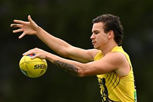 GOLD COAST, AUSTRALIA - OCTOBER 22: Daniel Rioli of the Tigers kicks during a Richmond Tigers AFL training session at Metricon Stadium on October 22, 2020 in Gold Coast, Australia. (Photo by Quinn Rooney/Getty Images)